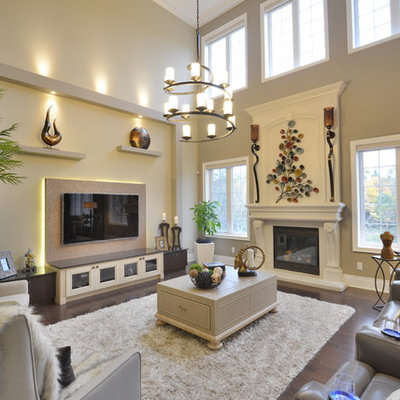 Inspiration for a mid-sized transitional open concept dark wood floor and beige floor family room remodel in Toronto with beige walls, a standard fireplace, a wall-mounted tv and a wood fireplace surround