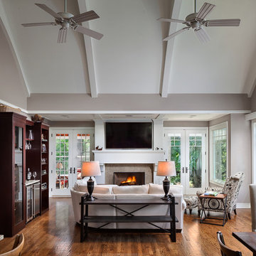 Great room features vaulted ceiling, beams, and 8' French doors