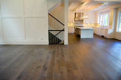 Large country open concept dark wood floor and brown floor family room photo in Vancouver with white walls and no tv