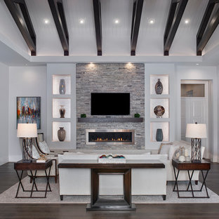 Large transitional open concept dark wood floor and brown floor family room photo in Miami with gray walls, a ribbon fireplace, a metal fireplace and a wall-mounted tv