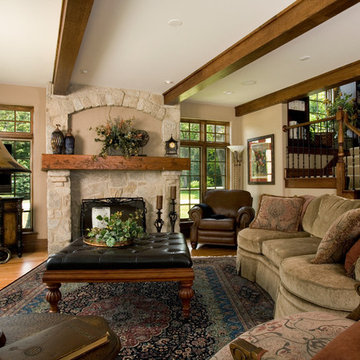 Great Room with Beamed Ceiling, Stone Fireplace and Iron Railing Staircase