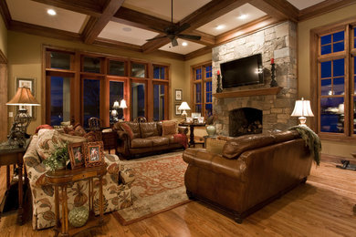 Large open concept light wood floor family room photo in Other with beige walls, a standard fireplace, a stone fireplace and a wall-mounted tv