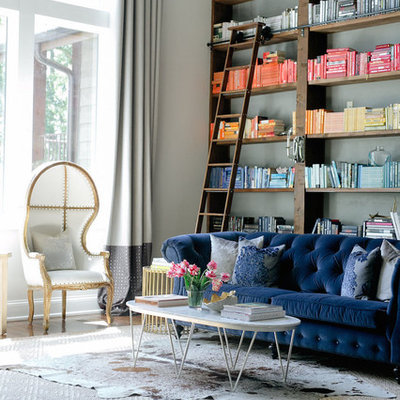 Family room library - large contemporary open concept medium tone wood floor and brown floor family room library idea in Nashville with gray walls