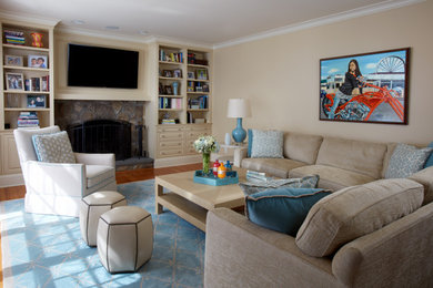 Family room - transitional medium tone wood floor family room idea in Atlanta with beige walls and a wall-mounted tv