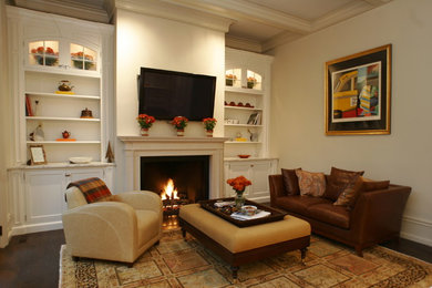 Diseño de sala de estar con biblioteca cerrada contemporánea grande con paredes blancas, suelo de madera en tonos medios, todas las chimeneas y televisor colgado en la pared