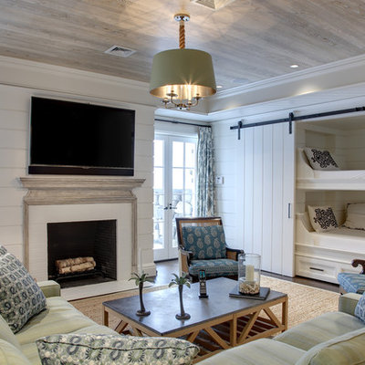 Example of a large classic medium tone wood floor and brown floor family room design in New York with a standard fireplace, a brick fireplace and white walls