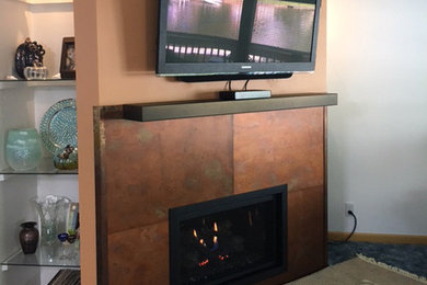 Inspiration for an industrial family room remodel in Grand Rapids with a corner fireplace and a metal fireplace