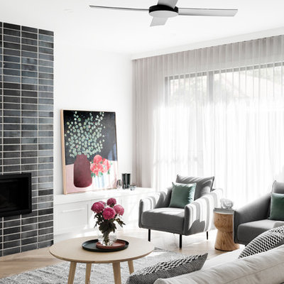 Family room - contemporary open concept medium tone wood floor and brown floor family room idea in Melbourne with white walls, a standard fireplace, a brick fireplace and a wall-mounted tv