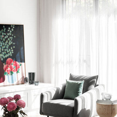 Family room - contemporary open concept medium tone wood floor and brown floor family room idea in Melbourne with white walls, a standard fireplace, a brick fireplace and a wall-mounted tv