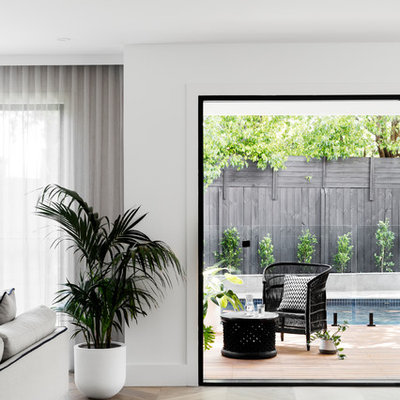 Trendy open concept medium tone wood floor and brown floor family room photo in Melbourne with white walls, a standard fireplace, a brick fireplace and a wall-mounted tv