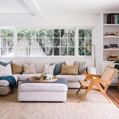 Inspiration for a mid-sized transitional dark wood floor and brown floor family room remodel in Los Angeles with white walls