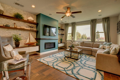 Trendy brown floor family room photo in Other with a stone fireplace