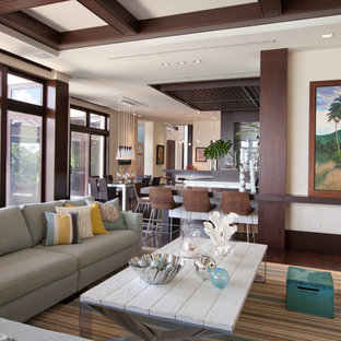 Mid-sized island style open concept carpeted and gray floor family room photo in Miami with beige walls and no fireplace