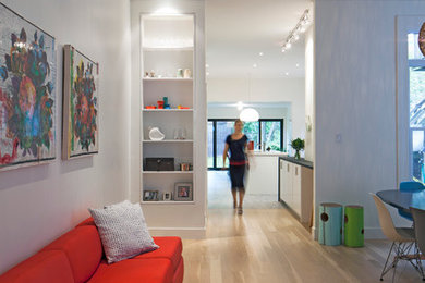 Inspiration for a mid-sized modern open concept light wood floor family room remodel in Toronto with white walls