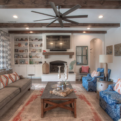 Inspiration for a transitional enclosed dark wood floor and brown floor family room remodel in Dallas with white walls, a standard fireplace and a wall-mounted tv