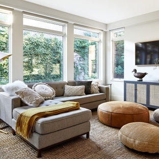Mid-sized transitional medium tone wood floor and brown floor family room photo in Los Angeles with white walls and a wall-mounted tv