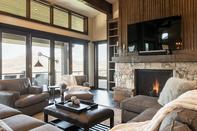 Inspiration for a rustic open concept dark wood floor and brown floor family room remodel in Salt Lake City with beige walls, a standard fireplace, a stone fireplace and no tv