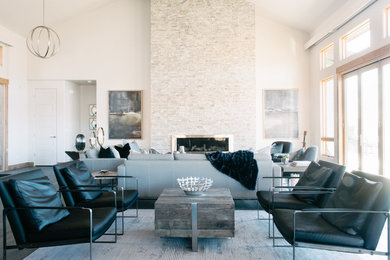 Example of a large minimalist open concept dark wood floor family room design in Salt Lake City with white walls, a stone fireplace and no tv