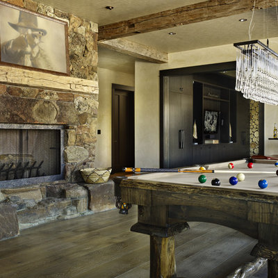Mountain style family room photo in Denver with beige walls, a standard fireplace and a stone fireplace