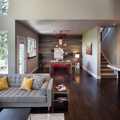 Example of a large trendy open concept dark wood floor and brown floor family room design in Portland with gray walls
