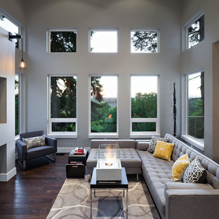 Large trendy open concept dark wood floor family room photo in Portland with gray walls and a ribbon fireplace