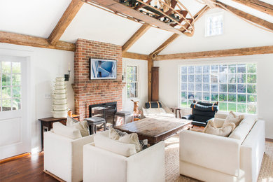 Family room - contemporary open concept dark wood floor family room idea in Boston with white walls, a two-sided fireplace, a brick fireplace and no tv