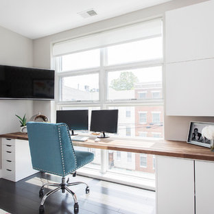 Inspiration for a small transitional enclosed family room in New York with grey walls, dark hardwood floors, no fireplace, a wall-mounted tv and brown floor.
