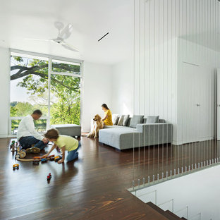 Family room - modern loft-style dark wood floor family room idea in Other with white walls, no fireplace and a tv stand