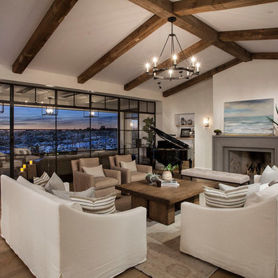 Tuscan open concept medium tone wood floor family room photo in Boise with a music area, white walls and a standard fireplace
