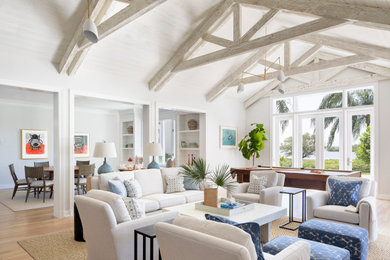 Inspiration for a coastal open concept light wood floor and beige floor game room remodel in Other with white walls