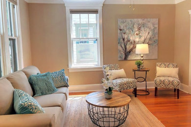 Inspiration for a small eclectic medium tone wood floor family room remodel in Philadelphia with beige walls