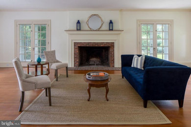 Family room - traditional medium tone wood floor family room idea in Philadelphia with white walls and a standard fireplace
