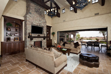 Example of a tuscan family room design in Orange County