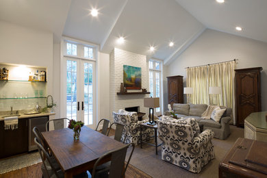 Imagen de sala de estar abierta clásica renovada grande con suelo de madera oscura, todas las chimeneas y marco de chimenea de ladrillo