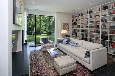 Minimalist family room library photo in Raleigh