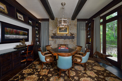 Example of a large transitional enclosed dark wood floor game room design in Houston with a tv stand, white walls, a standard fireplace and a stone fireplace
