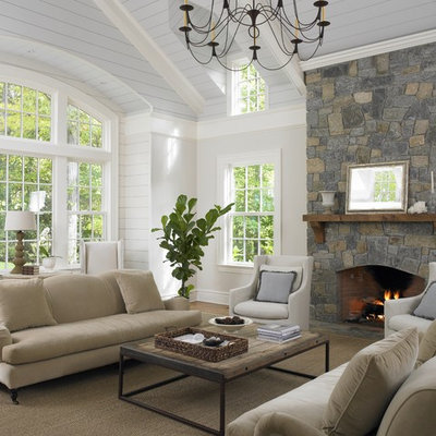Family room - traditional family room idea in New York with beige walls, a standard fireplace and a stone fireplace