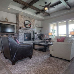 Large trendy open concept carpeted family room photo in Boise with a standard fireplace and a stone fireplace