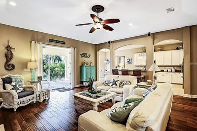 Example of an island style family room design in Tampa
