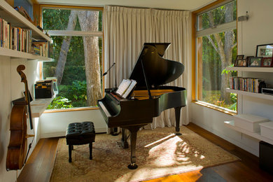 Inspiration for a mid-sized contemporary enclosed medium tone wood floor family room remodel in San Diego with a music area, white walls, no tv and no fireplace