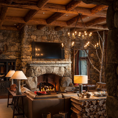 Inspiration for a rustic family room remodel in New York with multicolored walls, a standard fireplace, a stone fireplace and a wall-mounted tv