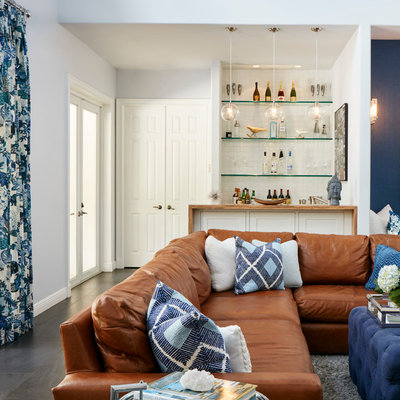 Family room - transitional open concept porcelain tile family room idea in Miami with a bar, a wall-mounted tv and gray walls