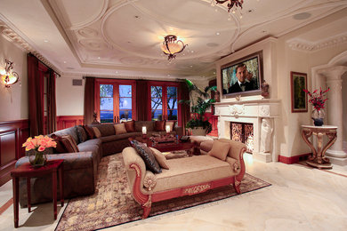 Example of a large tuscan family room design in Orange County with a standard fireplace and a wall-mounted tv