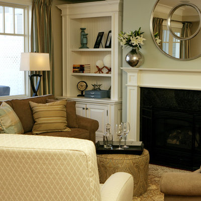 Family room - mid-sized traditional open concept family room idea in Toronto with a standard fireplace, a wood fireplace surround, a media wall and gray walls