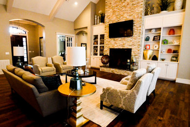 Family room - large transitional open concept dark wood floor family room idea in Other with beige walls, a standard fireplace, a stone fireplace and a wall-mounted tv