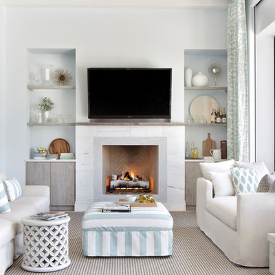 Family room - coastal enclosed family room idea in Miami with white walls, a standard fireplace and a wall-mounted tv