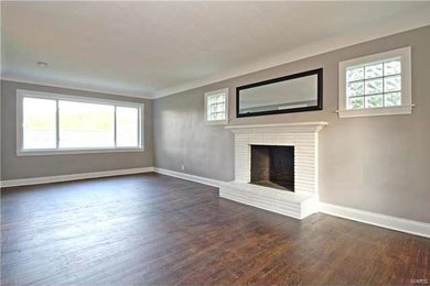 Foto de sala de estar cerrada clásica grande con paredes blancas, suelo de madera oscura y suelo marrón