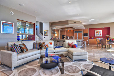 This is an example of a contemporary open plan games room in Orange County with multi-coloured walls, limestone flooring, a standard fireplace, a stone fireplace surround and a built-in media unit.