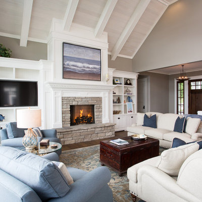 Mid-sized beach style open concept dark wood floor and brown floor family room photo in Other with beige walls, a standard fireplace, a stone fireplace and a wall-mounted tv