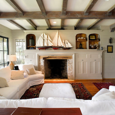 Example of a mountain style medium tone wood floor family room design in Dallas with beige walls, a standard fireplace and a brick fireplace